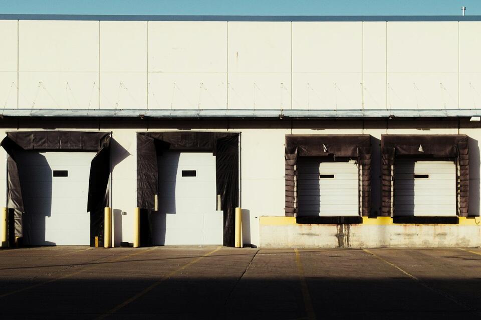 Row of loading dock doors on a warehouse building